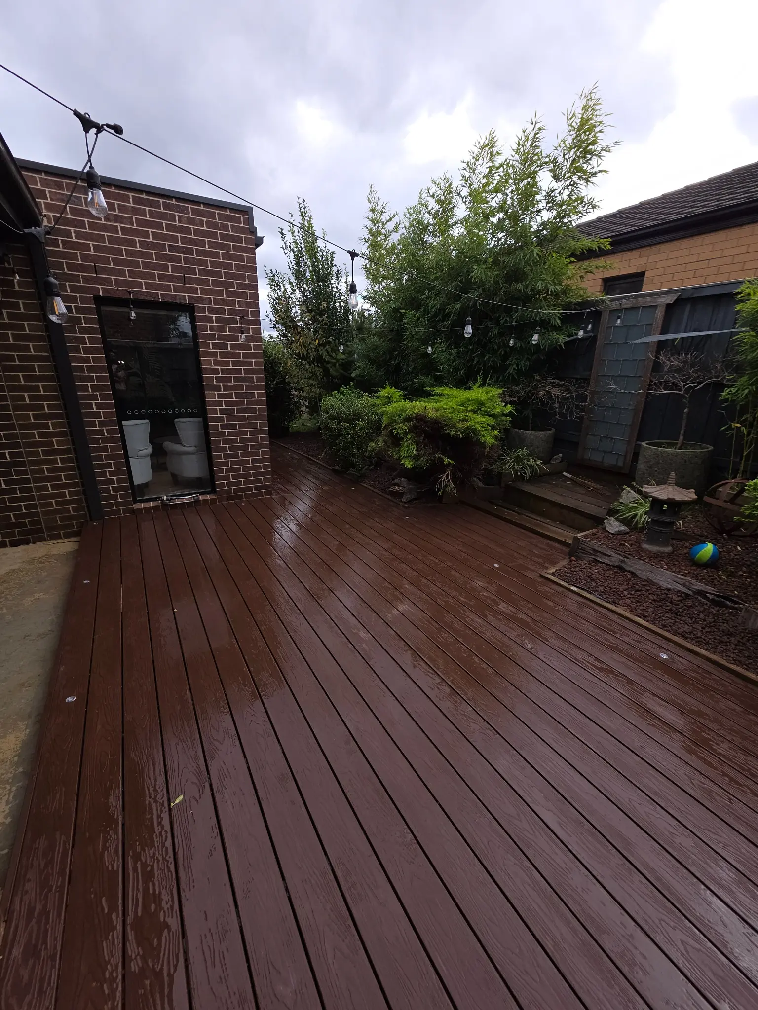 Completed timber deck integrated around an established backyard garden